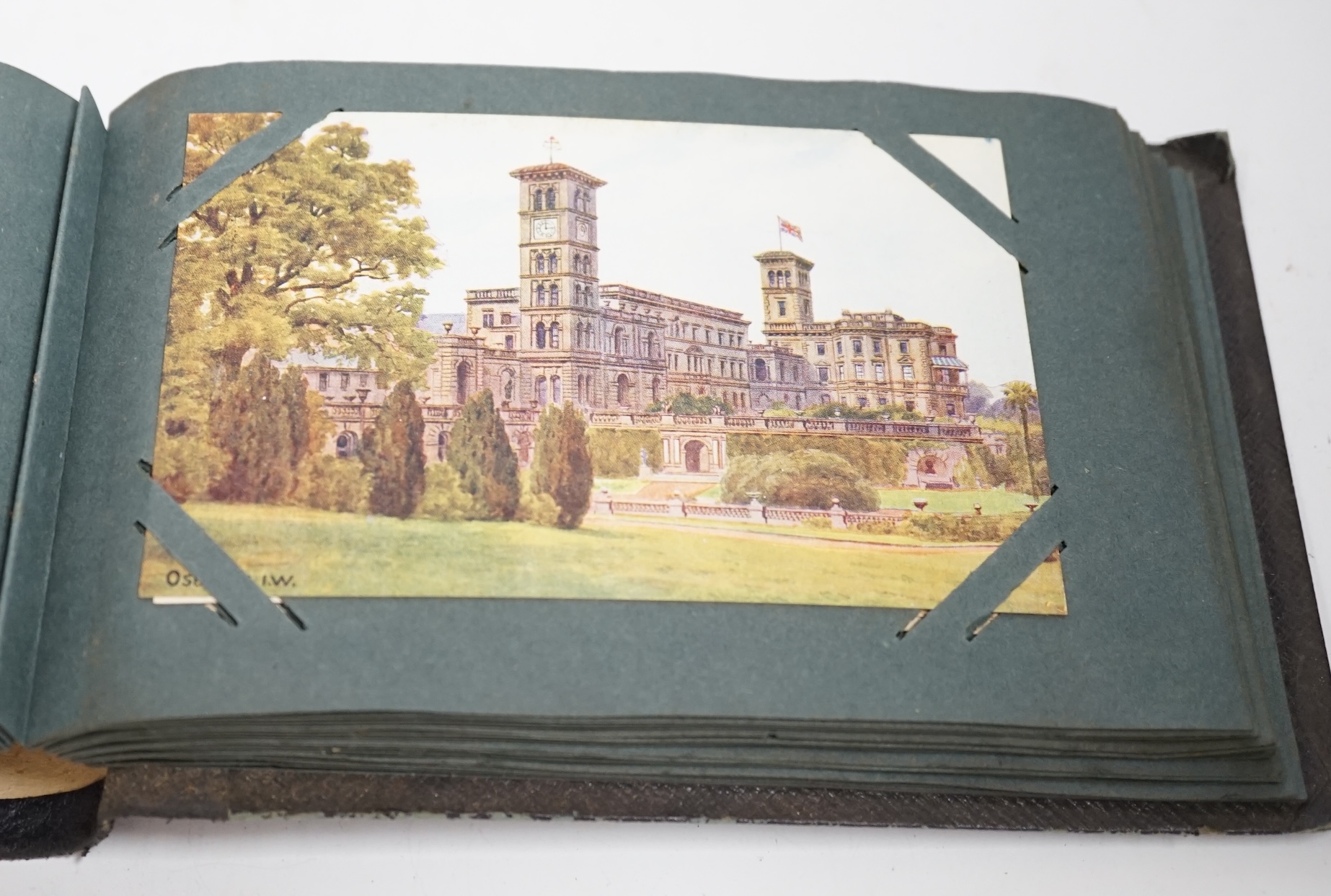 Three postcard albums, topographical examples including the Isle of Wight